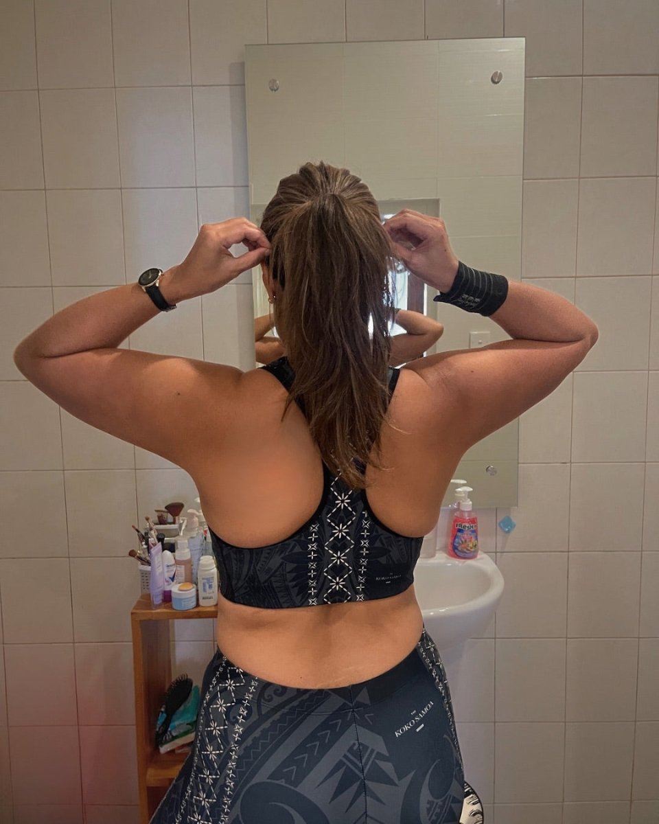 Black seamless sports bra by FYBY, Malu line, featuring subtle stitching and supportive design for active wear.