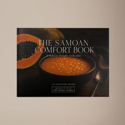 Hardcover keepsake book featuring 6 Samoan recipes, titled "The Samoan Comfort Book," by District Photo, with vibrant cover art.