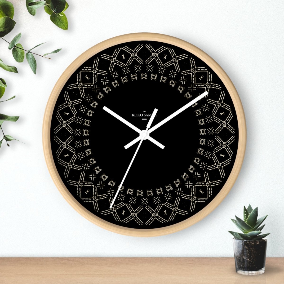 Black and white 10-inch Malu wall clock, featuring a modern home decor design with a round face and minimalist style.